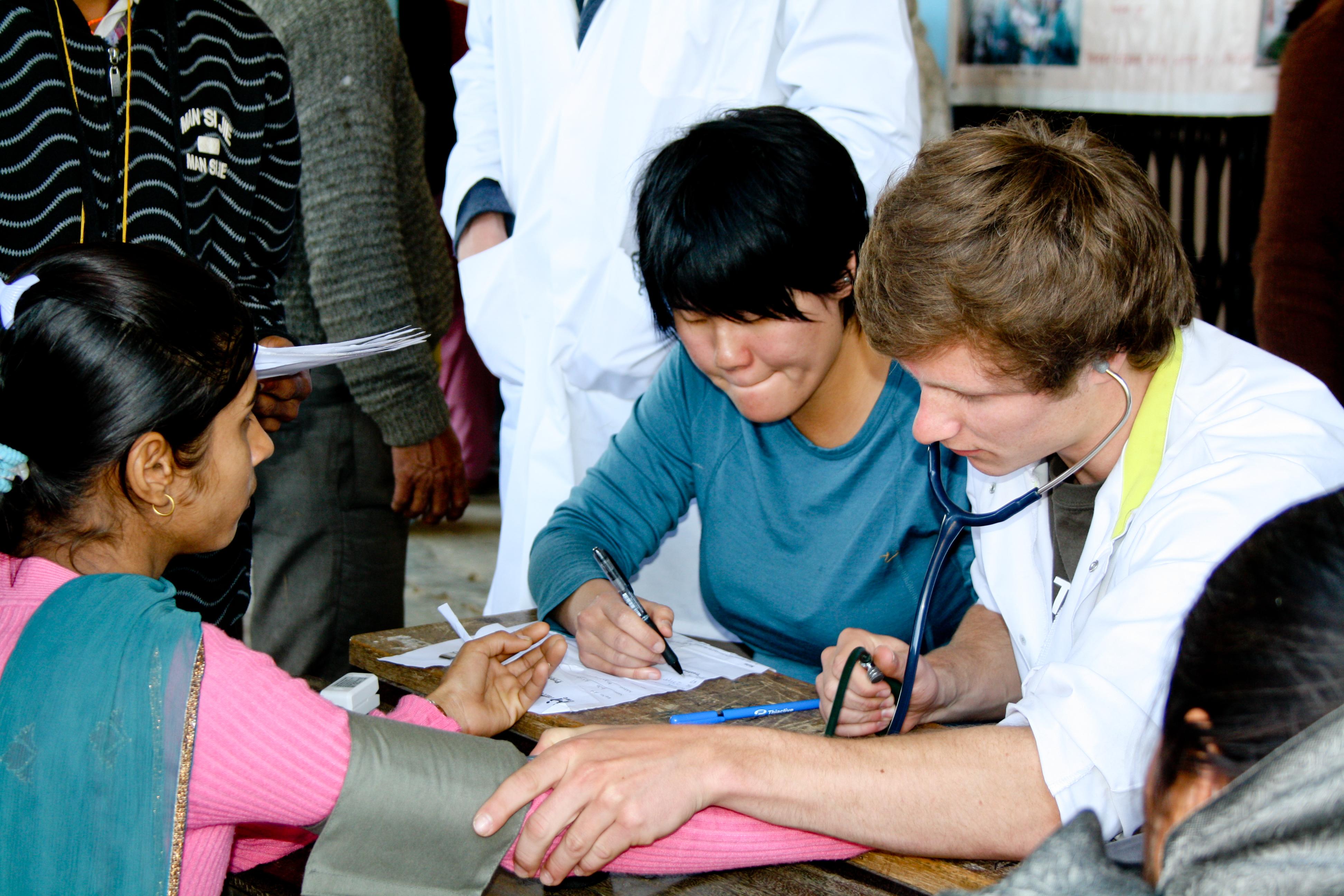 A male intern from Projects Abroad conducting a check up on a local woman during his nursing internship in Nepal. A male intern can be seen performing a check up on a local patient during his nursing internship in Nepal with Projects Abroad.